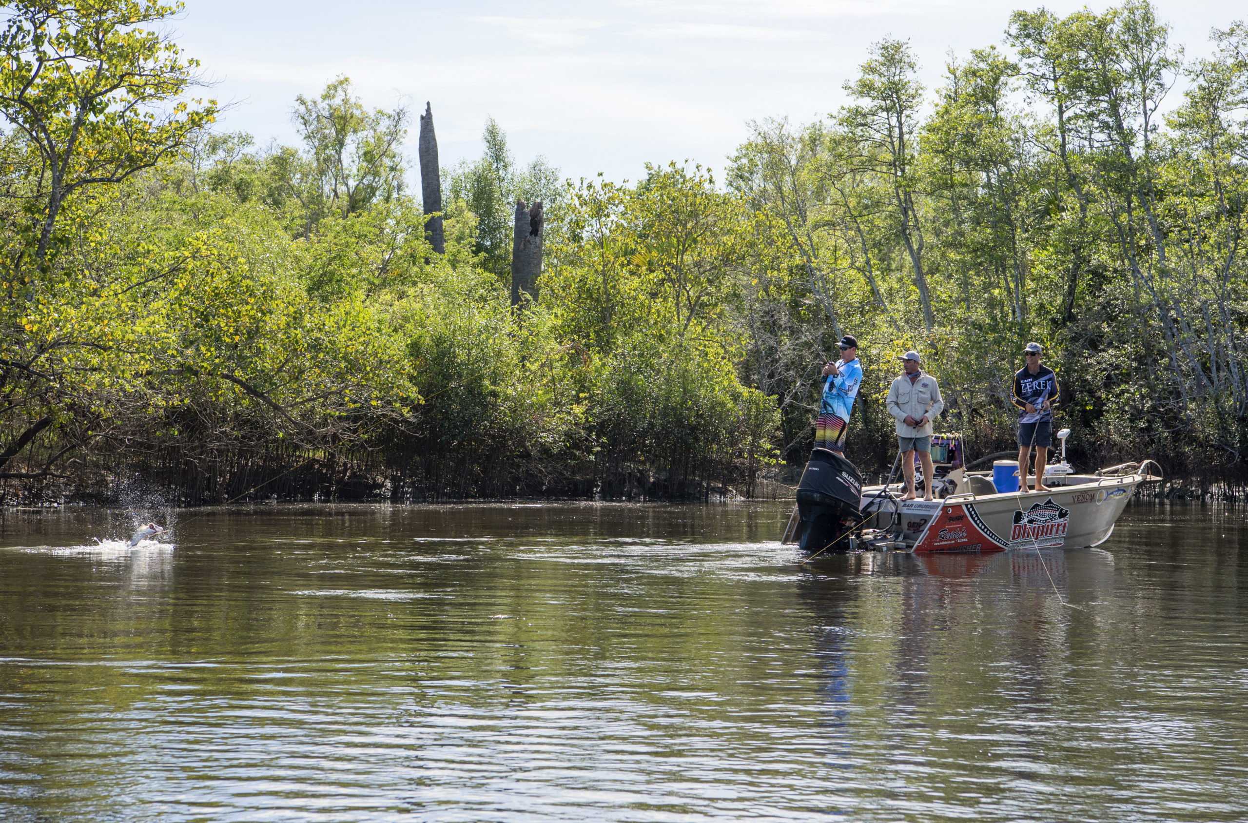 Men in aluminium dinghy catching a fish